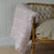 A floral paisley print quilt with a rose pattern, showing its soft texture and delicate design.
