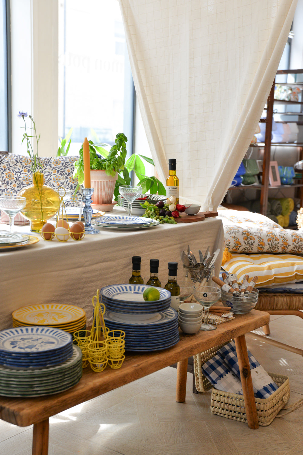 Dining area with plates, glasses, and decorative items on a wooden table. 